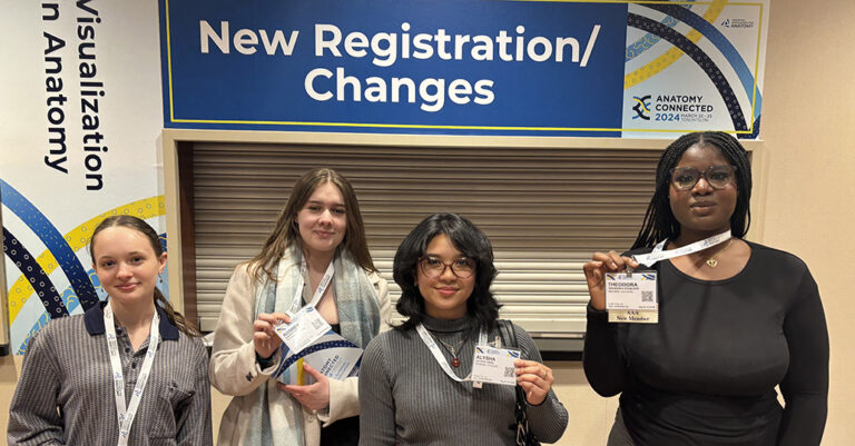 Anatomy Connected attendees holding badges