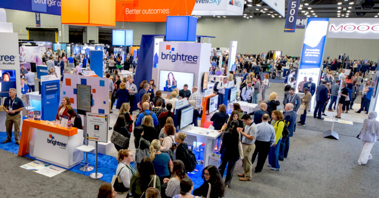 Participants crowd around booth at NHIA Expo