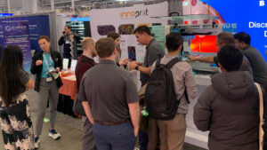 Exhibitors engage with attendees during an SLAS 2026 booth demo