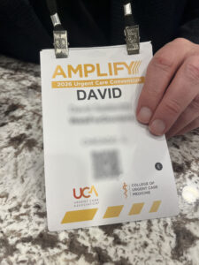 Image of a registration badge from UCA 2026 with identifying information blurred